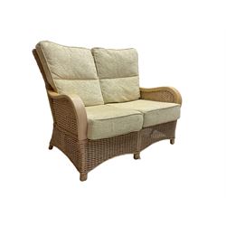 Contemporary rattan conservatory suite - two seat sofa with wicker frame and loose cushions upholstered in textured champagne fabric (W125cm H98cm); pair of matching armchairs (W72cm H98cm); rectangular glass-topped coffee table with rattan frame and undertier (W85cm D60cm H47cm); and matching square side table (W53cm H55cm)