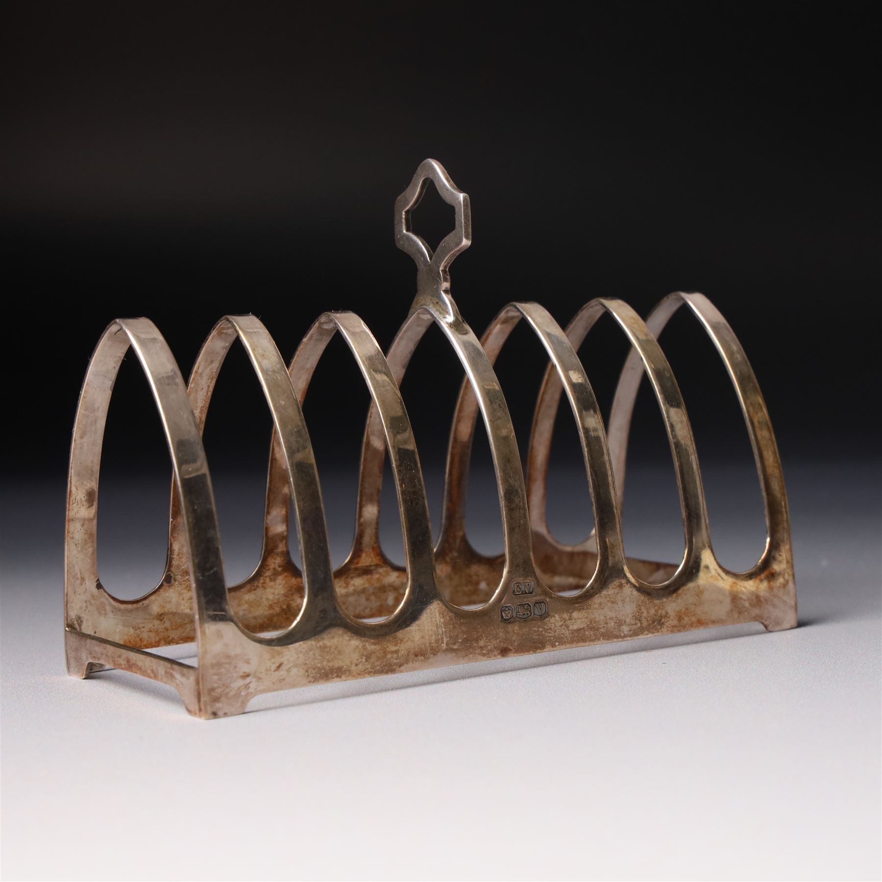 Silver six division toast rack with loop handle Sheffield 1938 Maker Viners and a silver butter knife