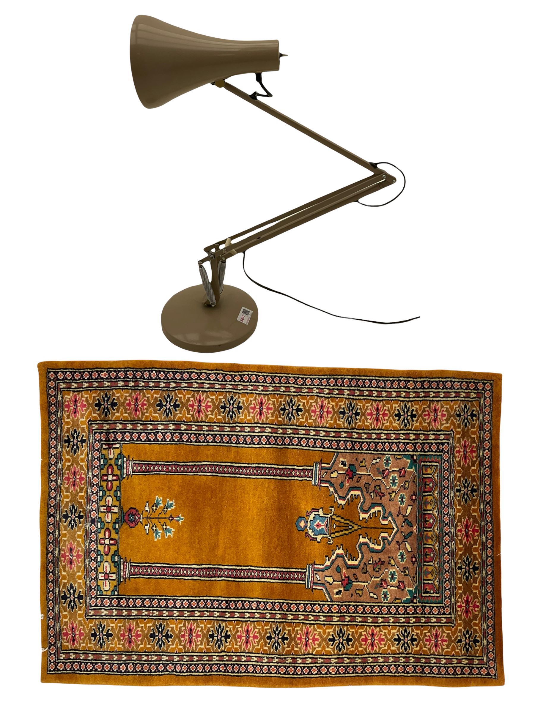Angle-poise lamp and an Islamic prayer mat