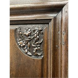 18th century French oak cupboard, projecting moulded cornice over four doors and two drawers, the panelled doors carved with flower heads and foliage, on turned front feet