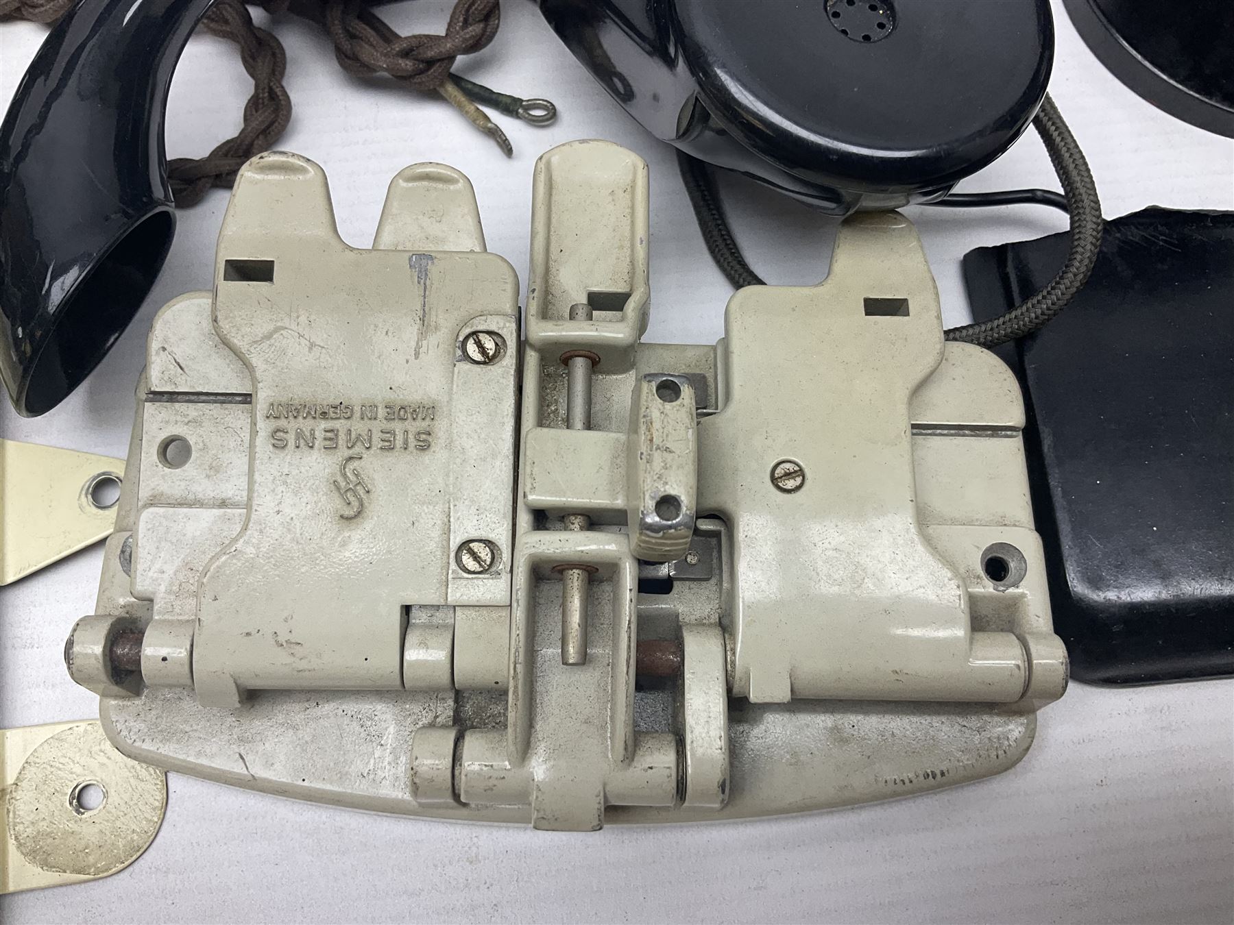 Collection of phone headsets, including GPO bakelite examples, together with other telephone parts 