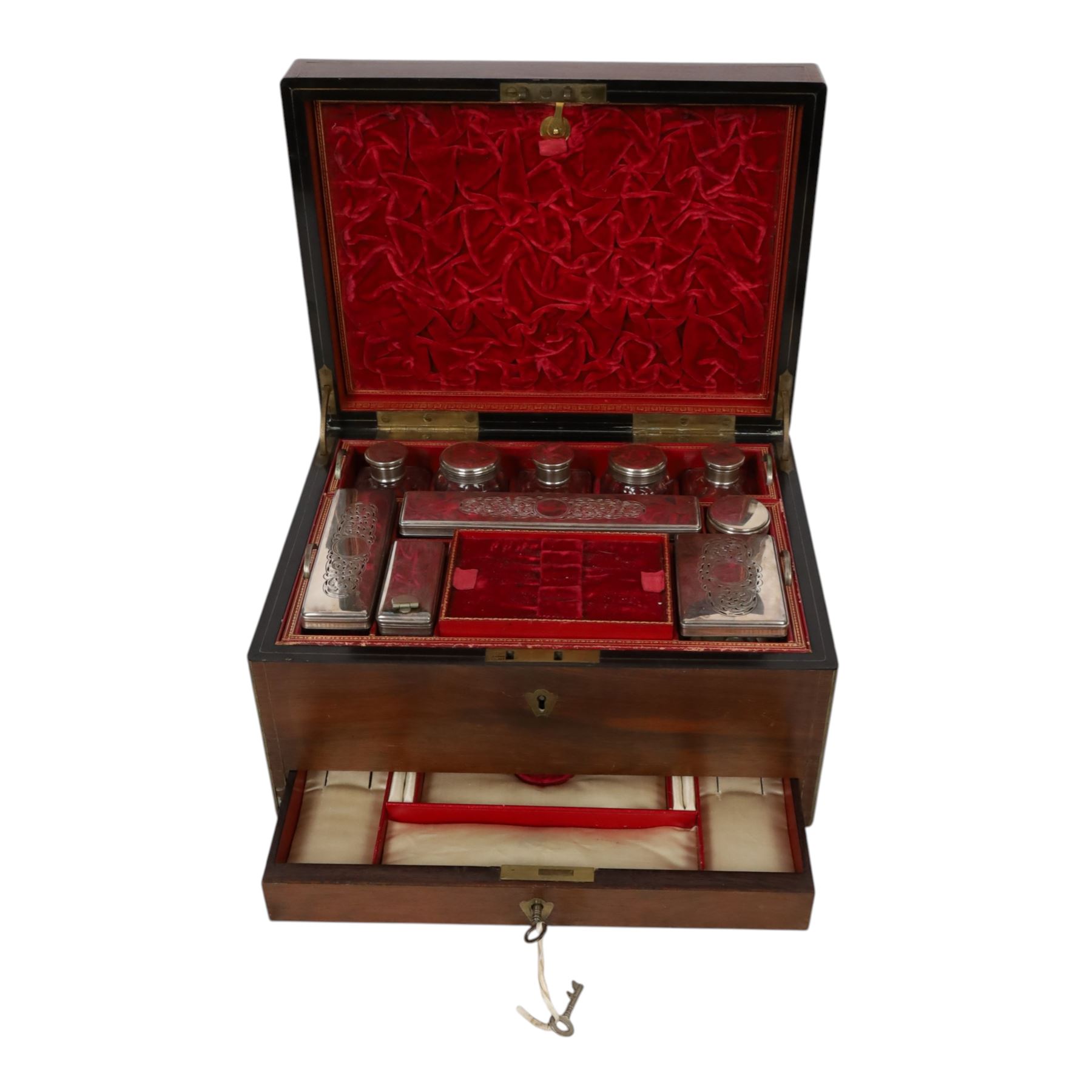  Victorian brass inlaid rosewood dressing table box, retailed by F.L. Hausburg, Liverpool, the lid centred by a brass cartouche, opening to reveal letter store to lid underside, above a fitted interior, with ten mounted cut glass jars, bottles and manicure set, within lift out leather trays, above jewellery drawer, with key, H17cm D24cm