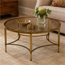Regency style brass and glass circular table, smoked glass top mounted to a brass frame with fluted supports united by stretchers