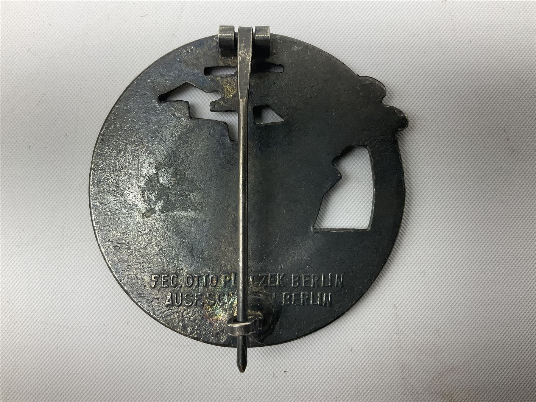 Three WW2 German badges comprising Blockade Runner War Badge and Coastal Artillery badge, both marked 'Fec Otto Placzec Berlin'; and Infantry Assault Badge; all with fixing pins (3)