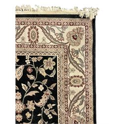 Persian design dark indigo ground rug, the field decorated with trailing branches and foliate motifs, repeating scrolling border with stylised plant motifs