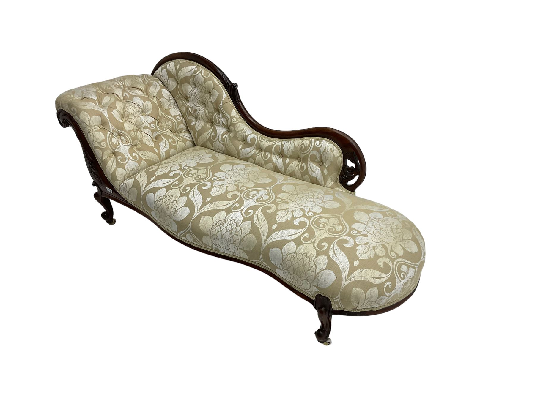 Victorian mahogany chaise longue, scrolled back with pierced and floral carved decoration, champagne foliate pattern fabric, cabriole feet with brass and ceramic castors