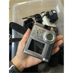 Collection of cameras and camera equipment, including Voigtlander Vitomatic I, Nikon Coolpix P340, Nikon Coolpix S9100, Olympus SP-510UZ, tripod, cases, etc