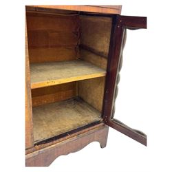 Late 19th century continental display cabinet, the upper section is glazed with twin doors with two upholster shelves, over a lower section with single draw above two glazed cupboard doors on shaped bracket feet