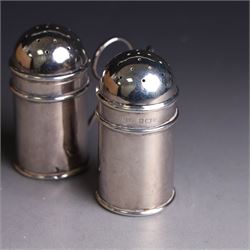 Pair of Edwardian silver muffineers, of cylindrical form with C scroll handles and removable pierced covers, hallmarked G E Walton & Co Ltd, Birmingham 1906, H6cm