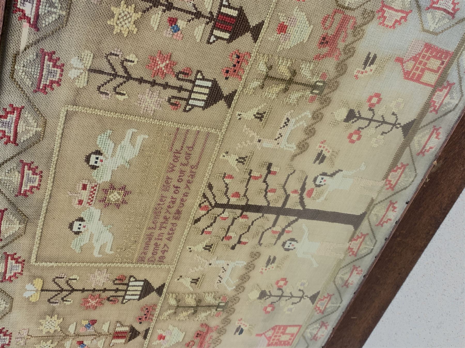 Victorian sampler, by Hannah Longster, Aged 11 years, dated 1847, worked with the Tree of Life, Adam and Eve, and various motifs including urns of flowers, lions, deer, and cherubs, within a stylised foliate border, in mahogany frame,  H49cm L56cm