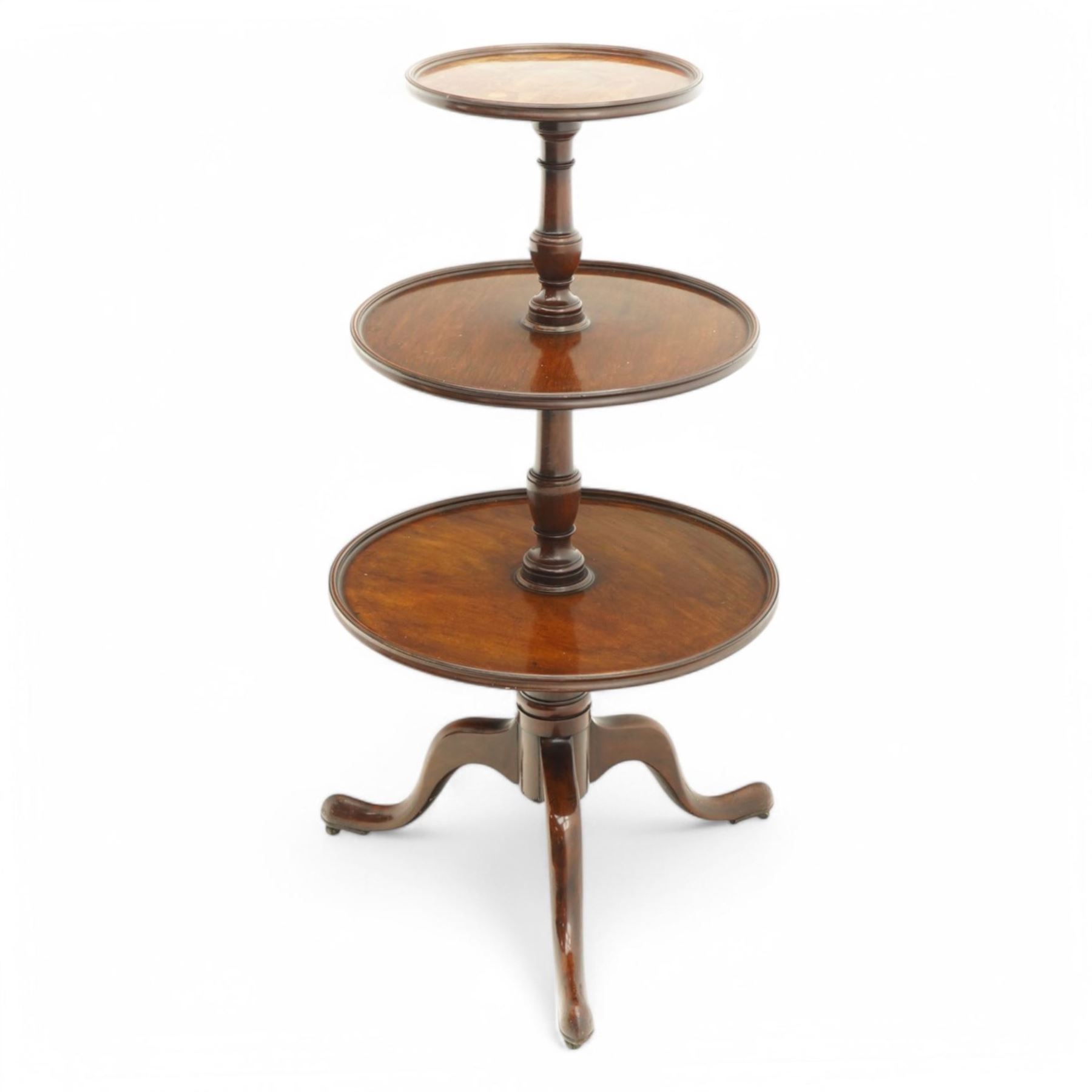 George III mahogany dumb waiter, three graduating circular tiers with moulded edges, turned column supports on tripod base, on castors 