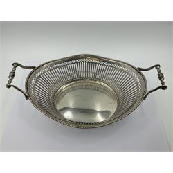 Early 20th century Dutch silver basket, of oval form with pierced sides, beaded rim, and twin handles, marked with Lion Passant for 2nd standard purity and date letter for 1910, other marks worn and indistinct, including handles H8.5cm L25.5cm