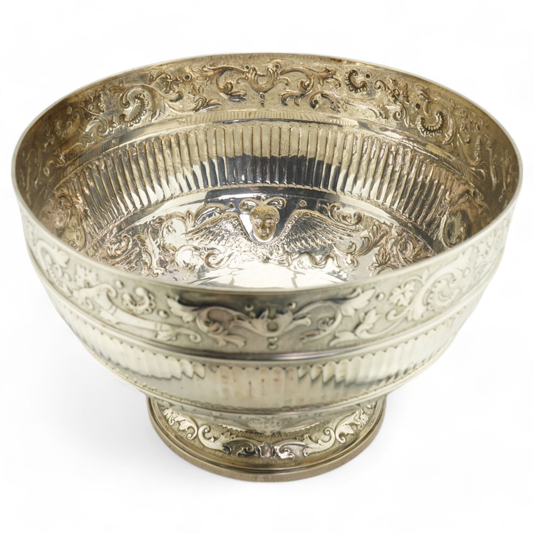 'Delwood Trophy in Memory of Col. H.H. Wilberforce' - A large Victorian silver rose bowl embossed with masks, wings, scrolls etc on a short pedestal foot D29cm London 1882 Maker Walter & John Barnard 