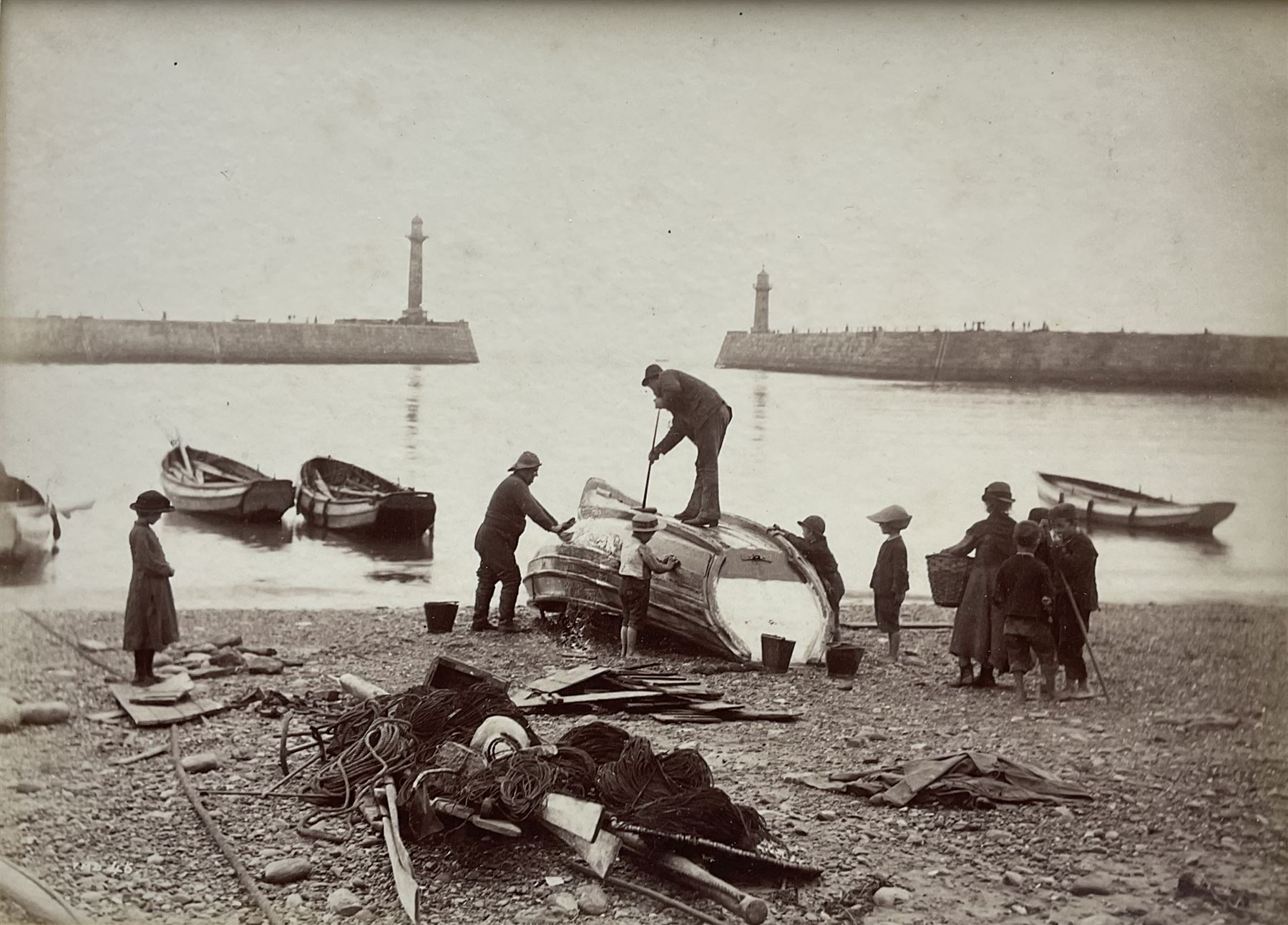 Frank Meadow Sutcliffe (British 1853-1941): Cleaning the Boat, albumen print c.1882 initialled and numbered 46 in the negative 15cm x 20cm (mounted)
Provenance: Witkin Gallery, New York; Sotheby's 25th April 1990 Lot 17; the Graham Nash Collection