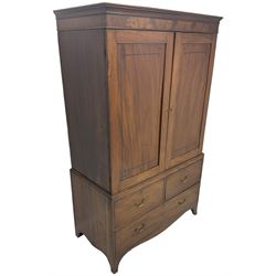 19th century mahogany linen press, projecting moulded cornice over figured frieze, enclosed by two panelled doors with geometric stringing, fitted with two short and one long cock-beaded drawers, on shaped apron and splayed bracket feet