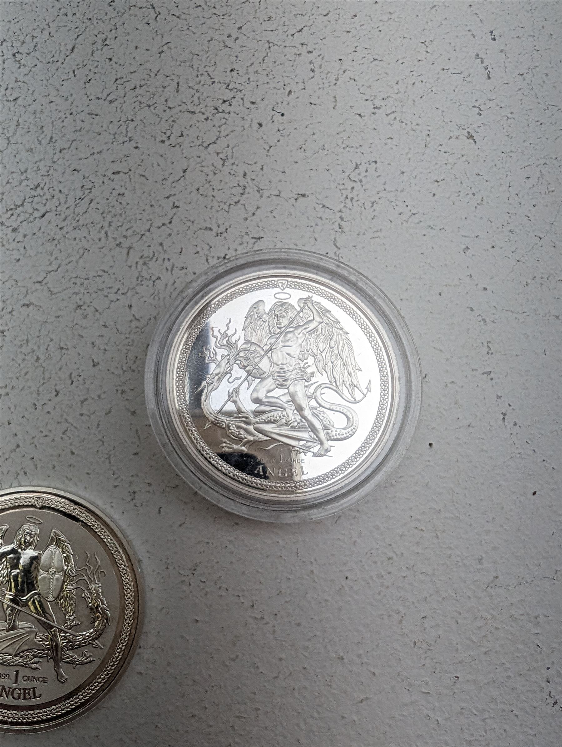 Three Queen Elizabeth II Isle of Man one ounce fine silver coins, comprising 2016, 2018 one angels and 2018 one noble 