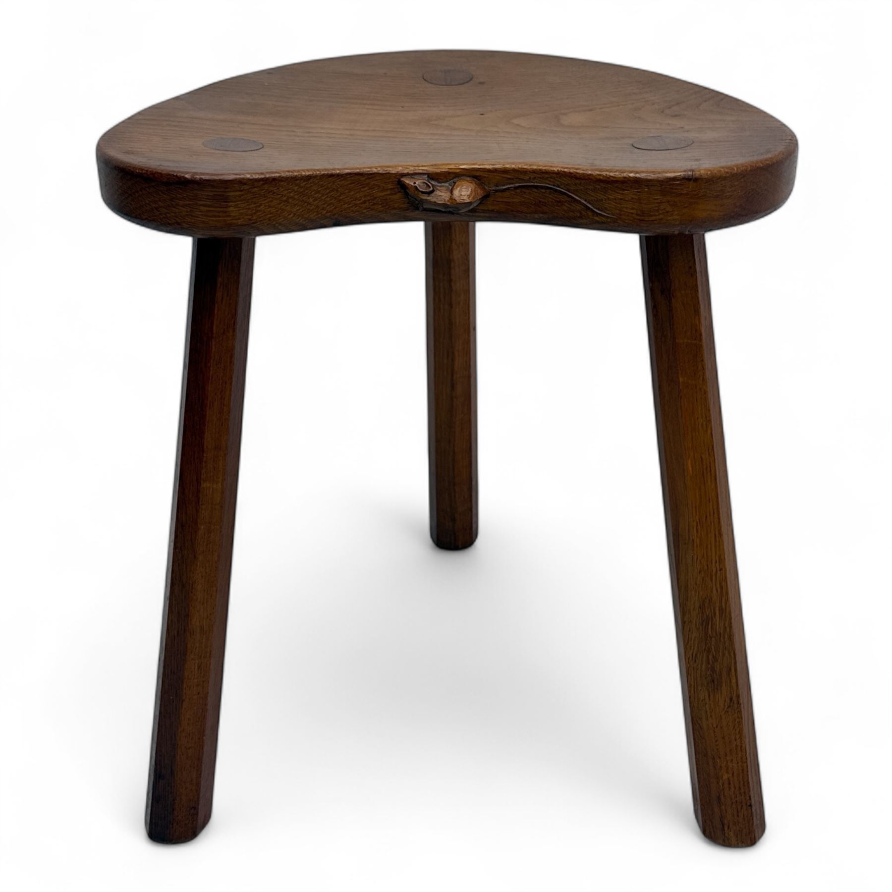 Mouseman - oak three-legged cow stool, kidney-shaped seat carved with the signature mouse motif, by the workshop of Robert Thompson, Kilburn