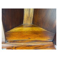 Late 20th century mahogany corner cabinet, dentil moulded cornice above a glazed door with astragal glazing enclosing two shelves, lower cupboard with fielded panel door and turned shell motif, on plinth base