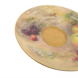 Royal Worcester fruit painted cabinet teacup and saucer, interior hand painted with apples, blackberry and cherries upon a mossy ground, the cup exterior and centre of saucer gilded, cup and saucer signed Rickells, each with puce coloured printed marks beneath, H7cm