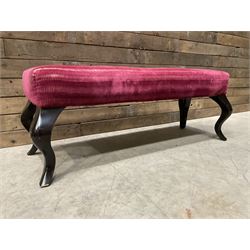 Large rectangular footstool upholstered in a maroon fabric with cabriole supports