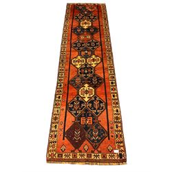 South West Persian Lori Runner, rust ground decorated with multiple interlocking medallions, the border decorated with stylised plat motifs