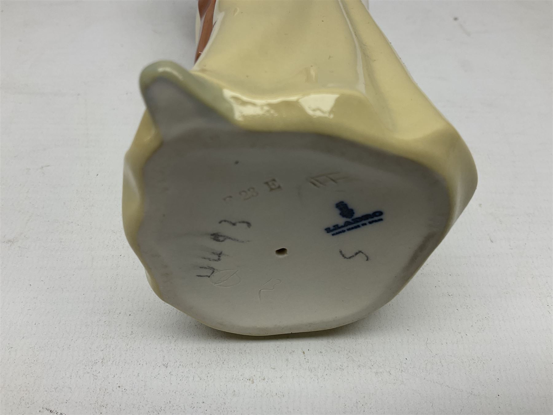 Three Lladro figures, comprising Little Jester no 5203, Pals Forever no 7686 and Naughty Girl no 5006, H25cm