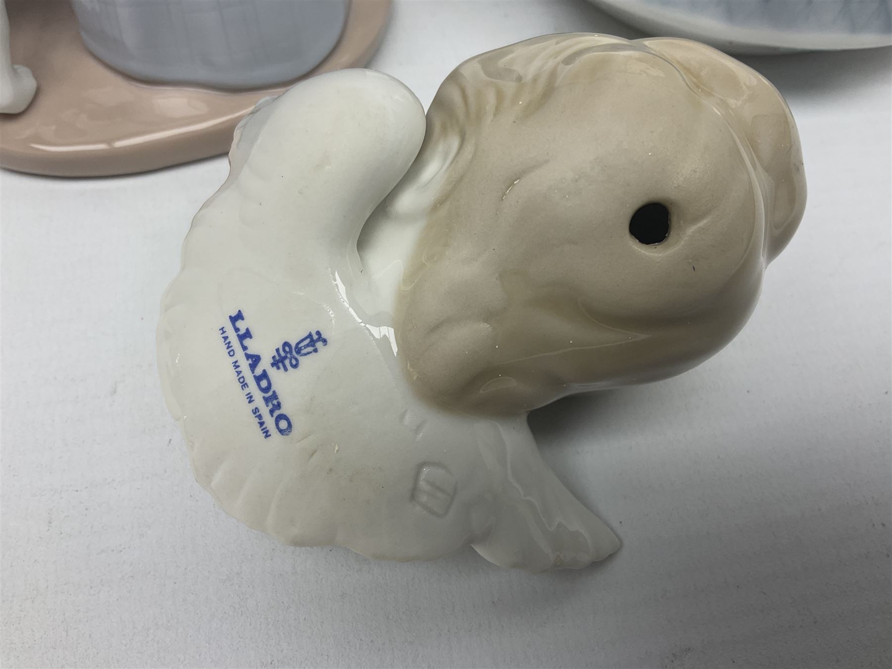 Three Lladro figures, comprising Dear Santa no 6166, Angelic Melody 1993 no 5963 and Seraphs Head no2 no 4885, together with Lladro plaque Love Brings Us Together no 7677, all with original boxes, largest example H18cm