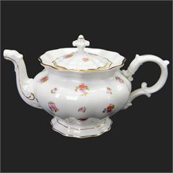 Forstenberg part tea and dinner service, comprising teapot, teacups and saucers, dinner plates, tureens, sauce boat, lidded sugar bowl, side plates and serving plates, all decorated with polychrome floral sprigs on a white ground with gilt edging