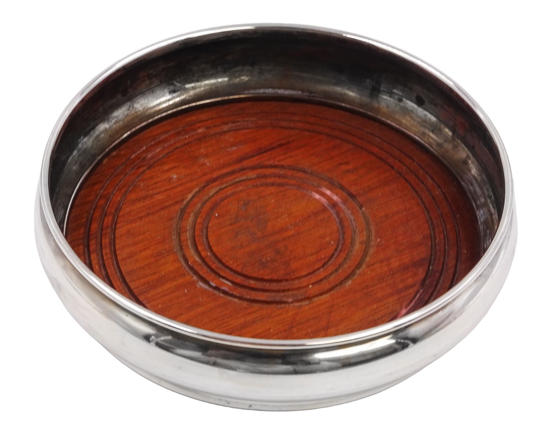 Modern silver mounted bottle coaster, of plain circular form with turned mahogany centre, hallmarked W I Broadway & Co, Birmingham 1979, D13cm