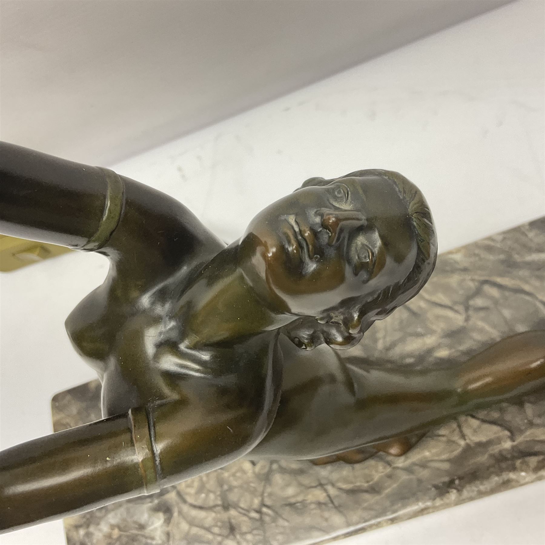1930s Art Deco spelter table lamp, modelled as a nude woman holding aloft a spherical crizzled glass shade, upon a marble base, H48cm