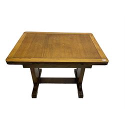 Oak rectangular extending dining table, shaped end supports with foliate decoration, on sledge feet