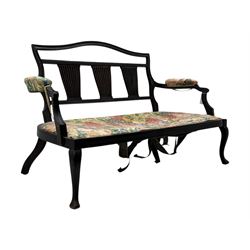 Edwardian mahogany three seater settee, upholstered in floral fabric. Shield back with padded armrests and cabriole legs  