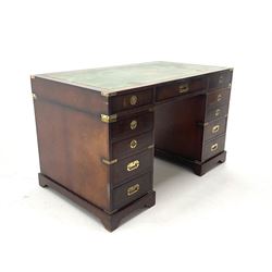 Mahogany campaign style kneehole desk, inset leather top, eleven graduating drawers, shaped plinth base 