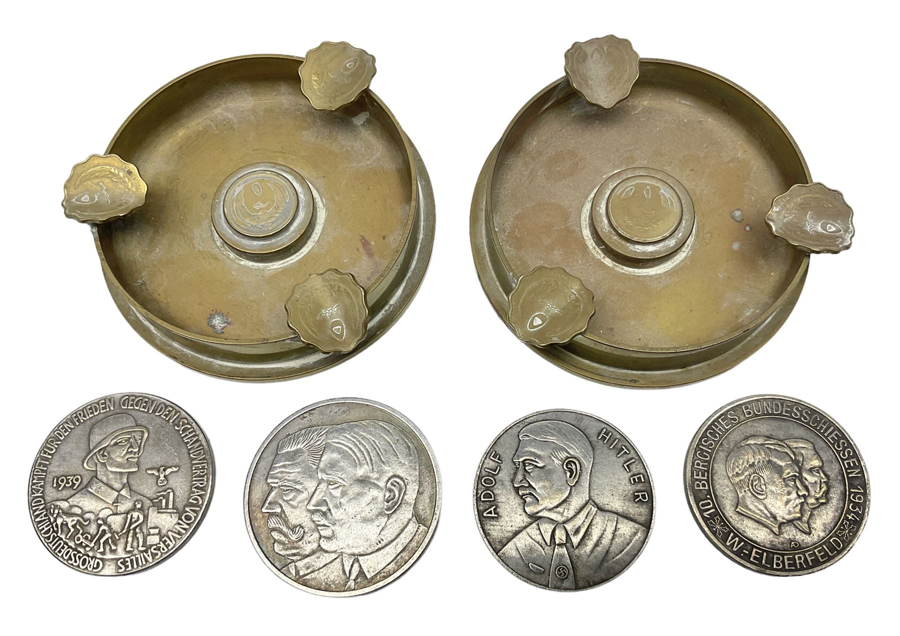 Four post-WW2 'silver' medallions of Adolf Hitler/German interest, two depicting Von Hindenburg also; and pair of 1960s trench art shell case bases as ashtrays mounted with Libyan Five Milliemes coins as cigarette rests (6)