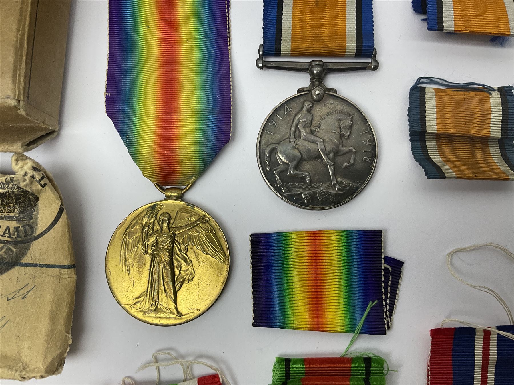 WWI pair of medals comprising British War Medal and Victory Medal awarded to 32682 Pte. W. Meadows W. Rid. R. in issue box; WWI pair of medals comprising 1914-15 Star and Victory Medal awarded to 3720 Pte. (later Cpl.) E. Petty W. York. R. with issue letter from Tank Corps; WWII group of five medals comprising 1939-45 War Medal, Defence Medal and 1939-45, Italy and Africa Stars; all with ribbons; and book of nineteen seaman's Certificates of Discharge to cook Charles Filburn 1893 - 1901 from various British ports