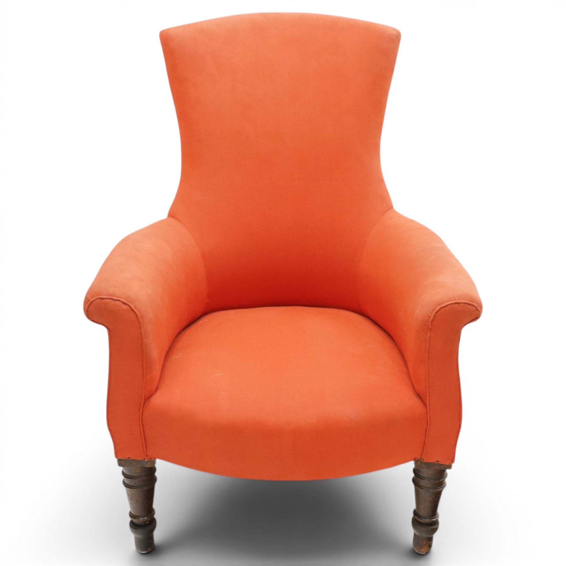 Victorian coral red upholstered armchair, the swept high back above padded arms with rolled fronts, on short turned ebonised front supports with castors