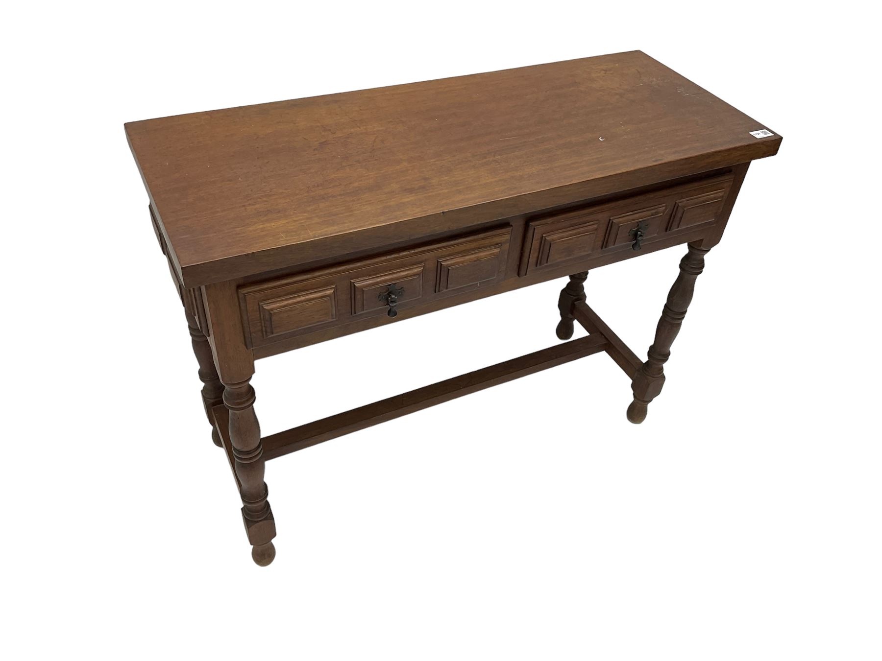 Spanish oak side table, fitted with two drawers with moulded facias, raised on turned supports united by stretcher