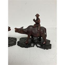 Pair of Chinese hardwood figures of farmers riding water buffalo, on stands, H19cm