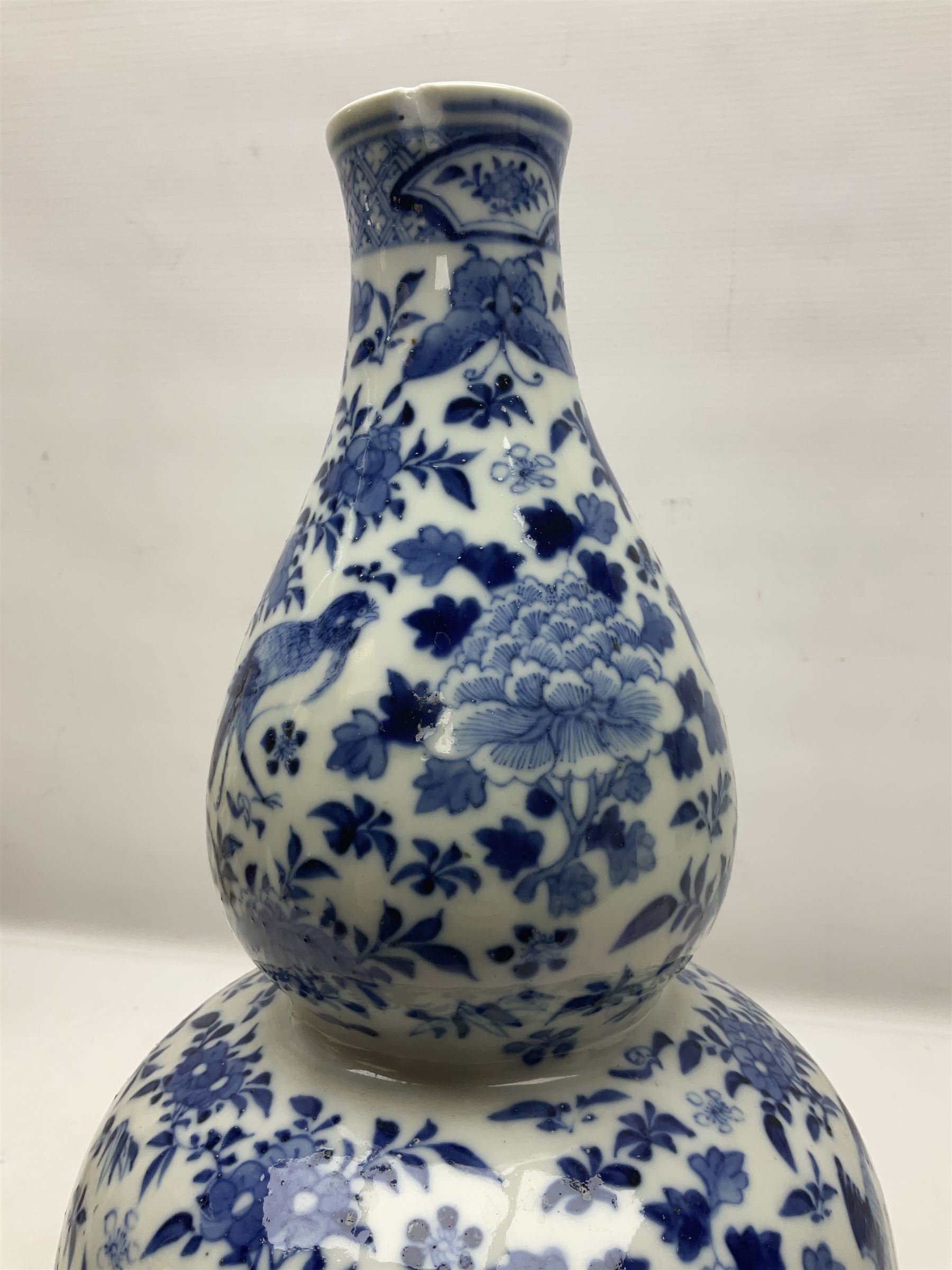 19th century Chinese blue and white double gourd form vase, decorated with blooming peonies and birds in flight, H36cm