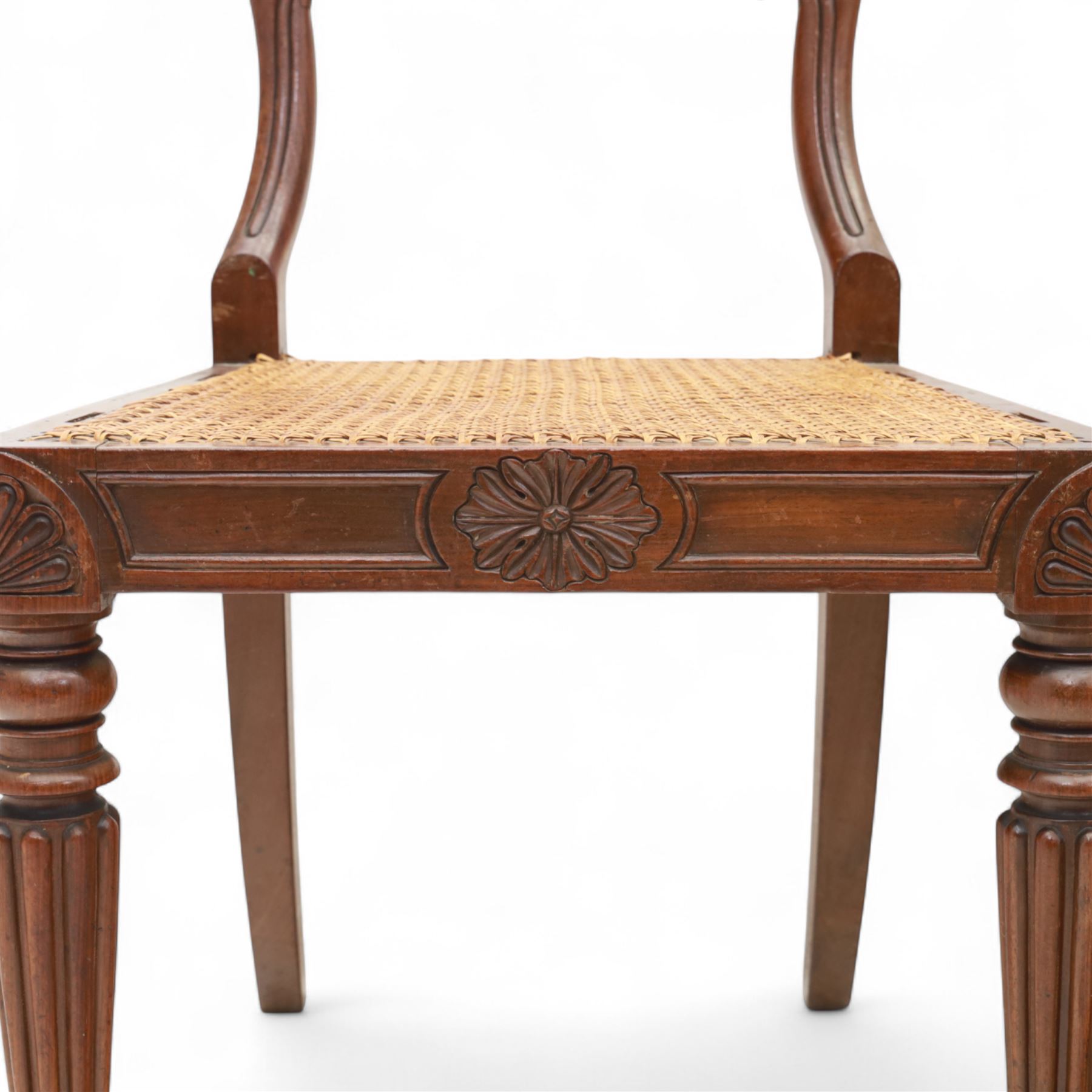 Gillows - Set of six mahogany dining chairs, each with curved top rail carved with floral medallion and scroll detail, fluted front supports, caned seats, the seat rail underside stamped HH identified as H. Howse an apprentice cabinetmaker at Gillows.