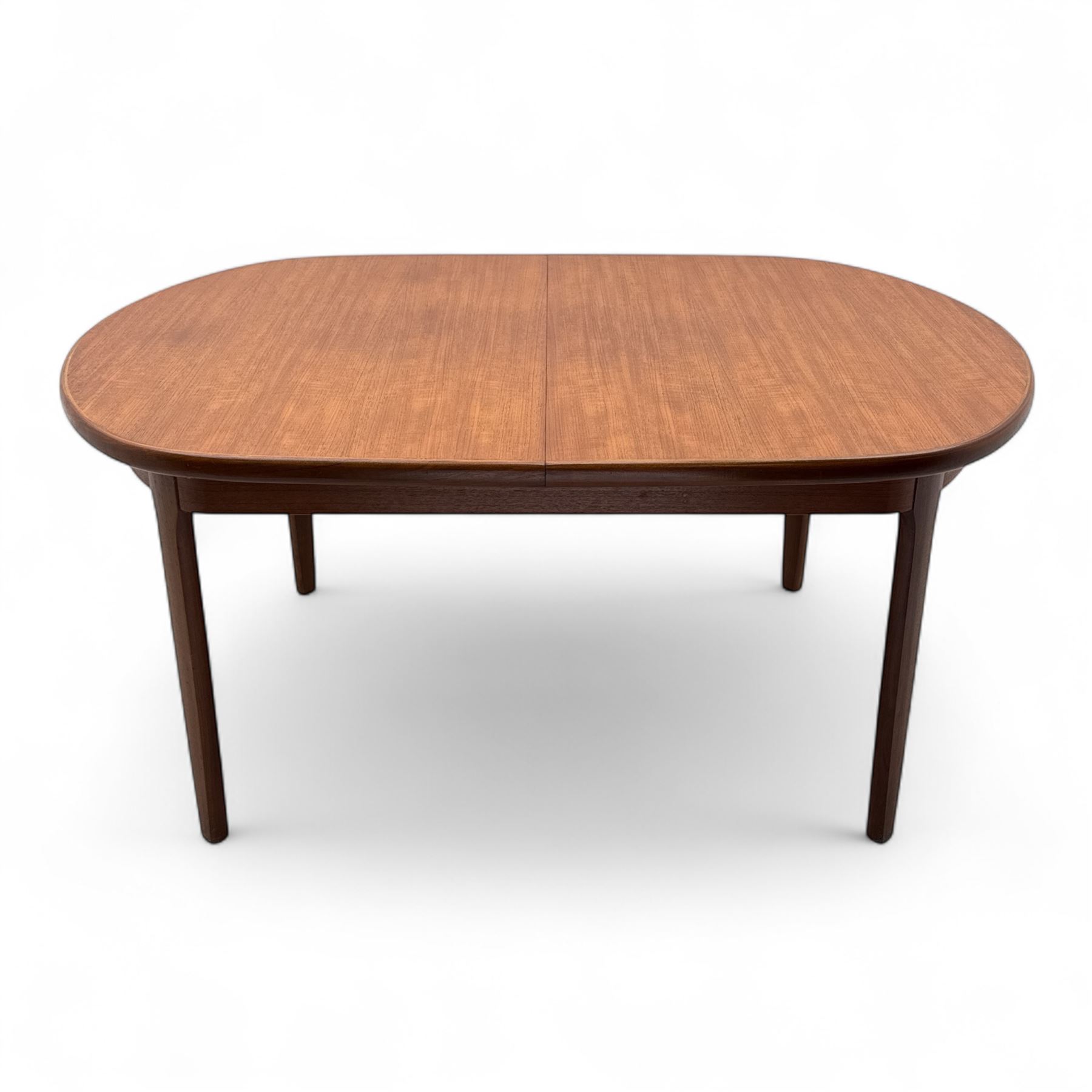 G-Plan - mid-20th century teak oval dining table, with butterfly leaf extension mechanism and four Elliot's of Newbury teak framed dining chairs upholstered in purple and green fabric, table un-extended width 152cm x depth 152cm x height 71cm, chairs 47x37x78cm 