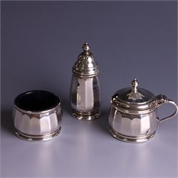 Mid 20th century three piece silver cruet set, comprising pepper shaker, open salt and mustard pot with cover, each of circular faceted form, hallmarked Walker & Hall, Birmingham 1958, the mustard pot and salt with blue glass liners