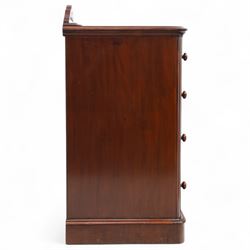 Pair of tall Victorian mahogany bedside chests, of narrow upright form, rectangular top with moulded edge, the back with raised pierced fretwork gallery, above four graduated drawers with knob handles, raised on a plinth base 