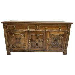Early 20th century oak sideboard, fitted with two drawers over three cupboards, decorated with half turned mounts