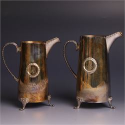 Two graduating silver milk jugs, each of tapering cylindrical form, with engraved central ...