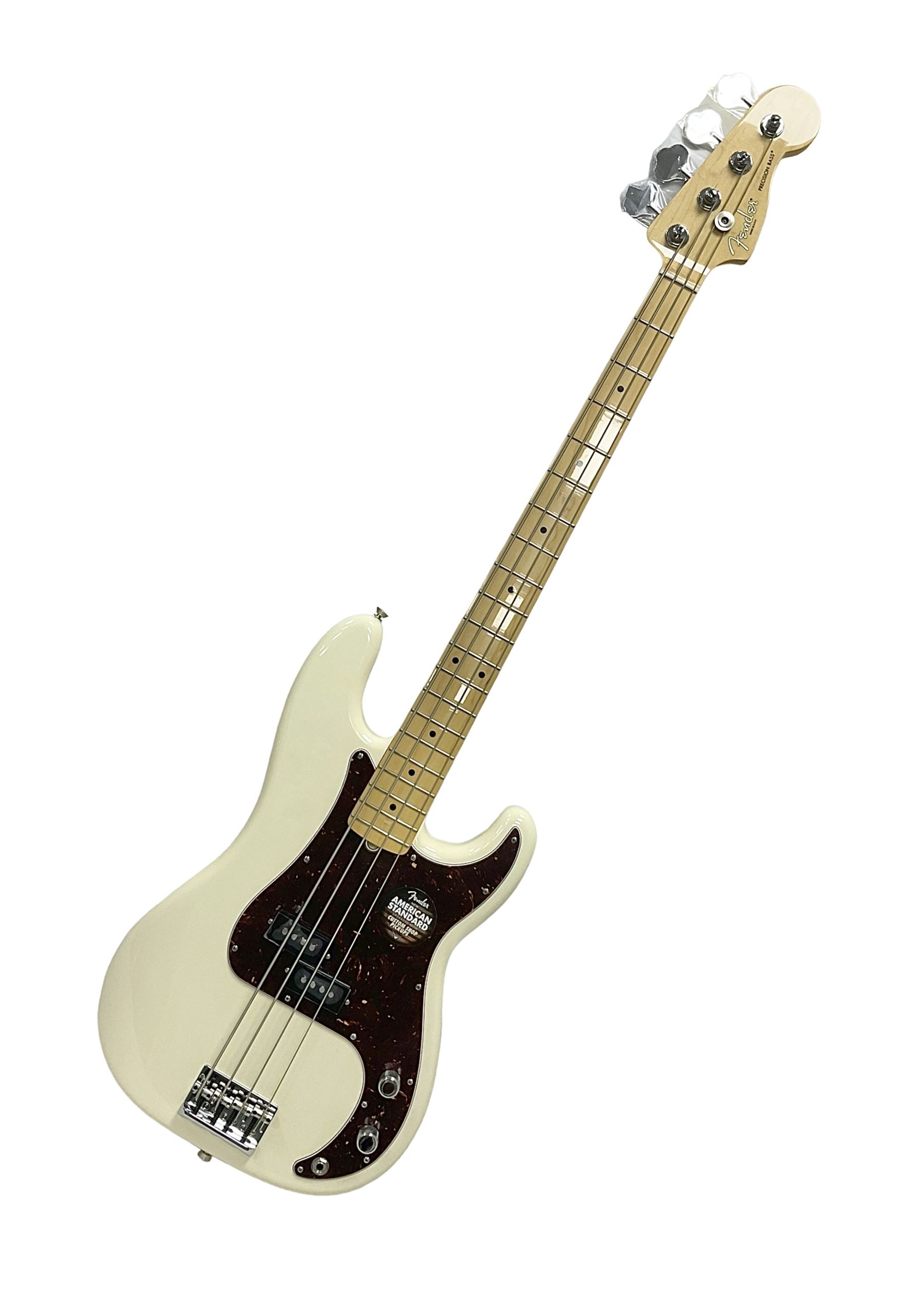 Fender Precision Bass guitar, in Olympic White finish with tortoiseshell effect scratchboard, serial no US15103092, in black Fender hard case with Fender strap and warranty card, guitar L116cm