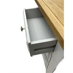 Pair of painted bedside chests with oak top, fitted with three drawers, raised on square supports with shaped apron, in cream finish