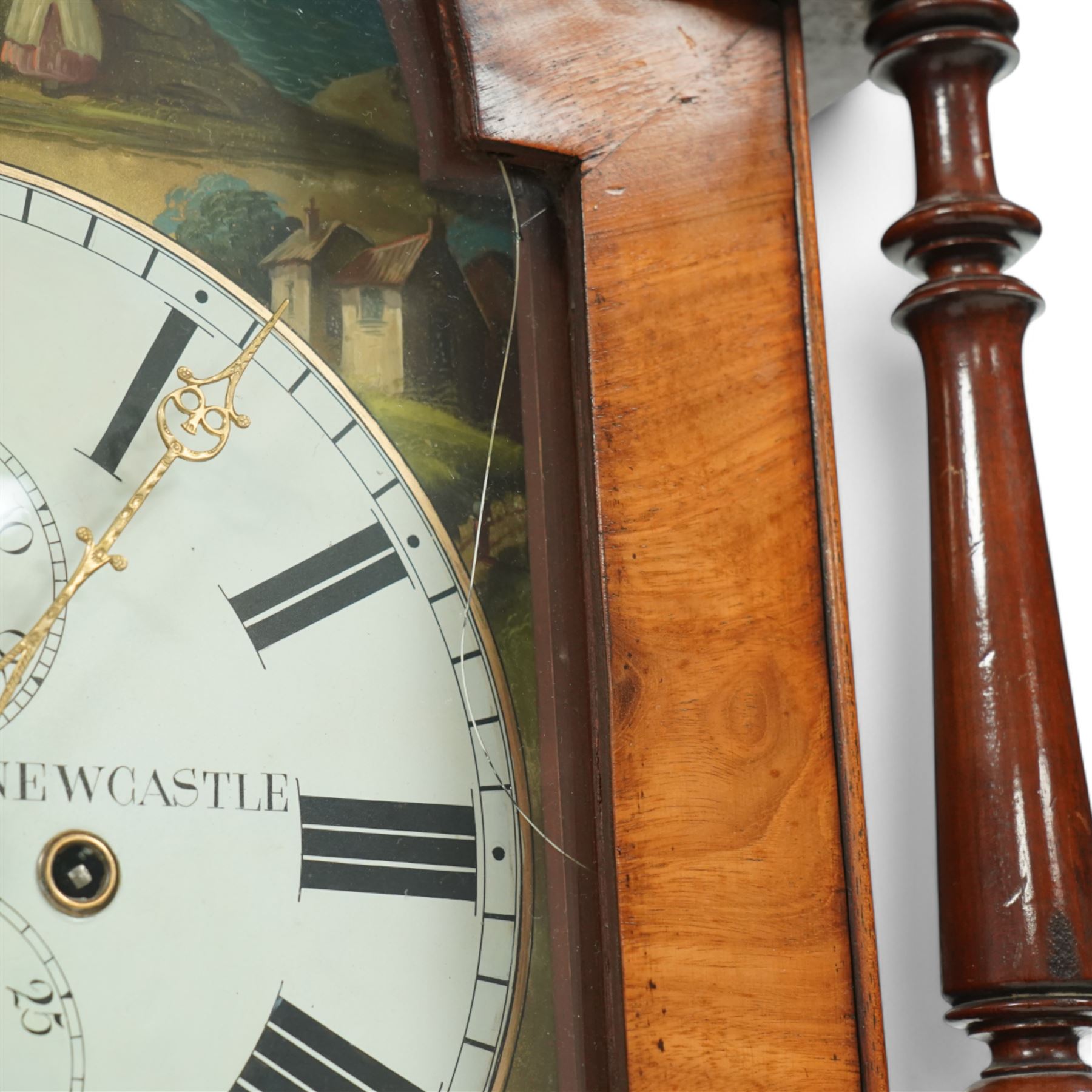 James Hall of Newcastle-Late19th century mahogany longcase clock c1870, with a swan necked pediment and break arch hood door beneath flanked by ring turned pilasters, trunk with half-round inset pilasters and a short panelled trunk door, on a square plinth with a recessed panel, painted dial with spandrels depicting country cottages and a coastal scene of a child and fisherman to the arch, with Roman numerals, minute track, date and seconds dial and stamped brass hands, dial attached via a false plate to a rack striking movement striking the hours on a bell. With weights and pendulum. 
James Hall is recorded as working  from King Street Newcastle-upon-Tyne from 1850 onwards. 
This clock was the subject of a detailed article on both the clock and maker, published in CLOCKS magazine in 2009. 