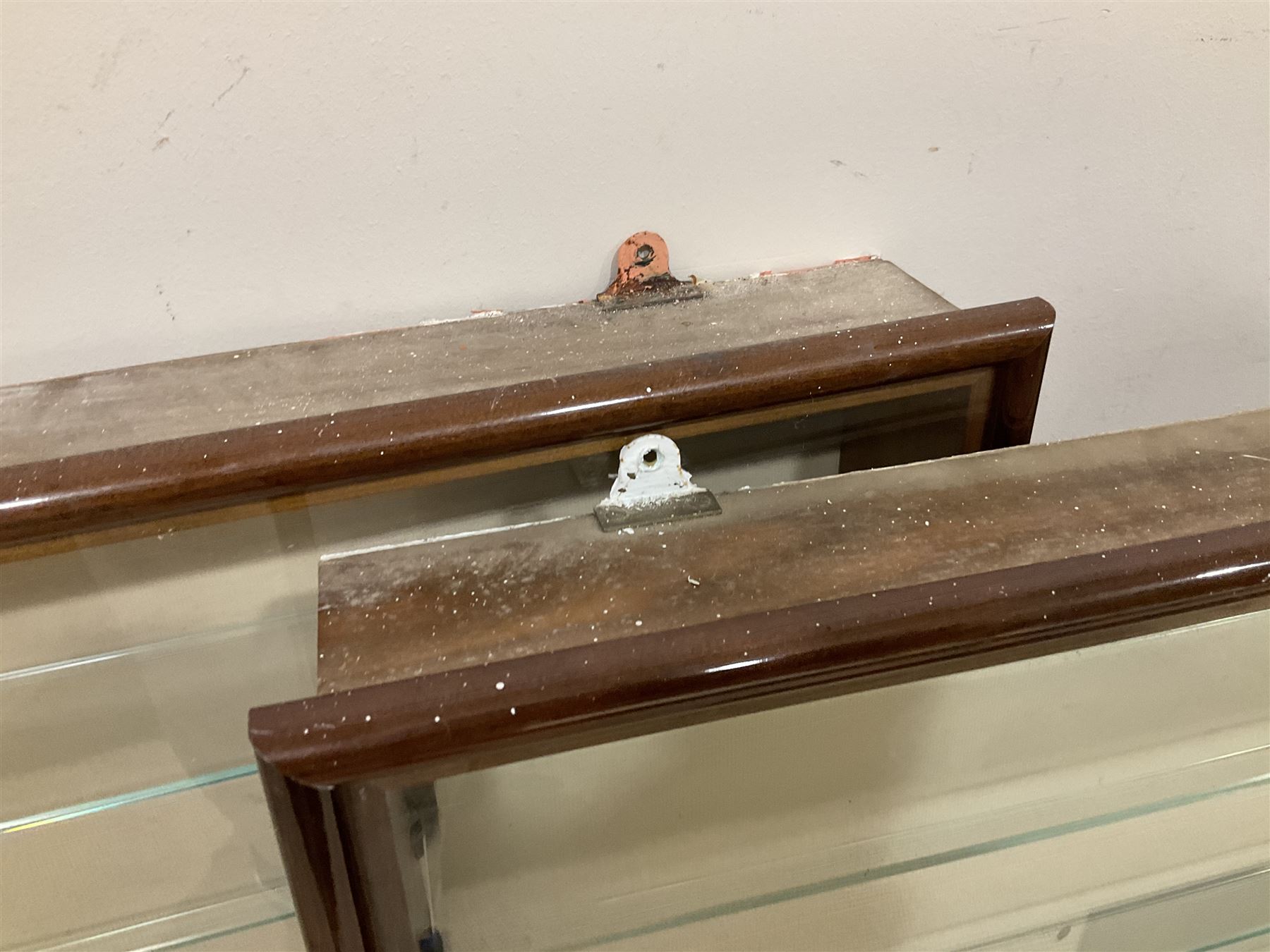 Four die-cast model wall mounting display cases by Picture Pride Displays Sandwell; each with mahogany stained frames and glazed fronts; three 83 x 75.5cm with eleven plate glass shelves and one 57 x 106cm with five plate glass shelves (4)