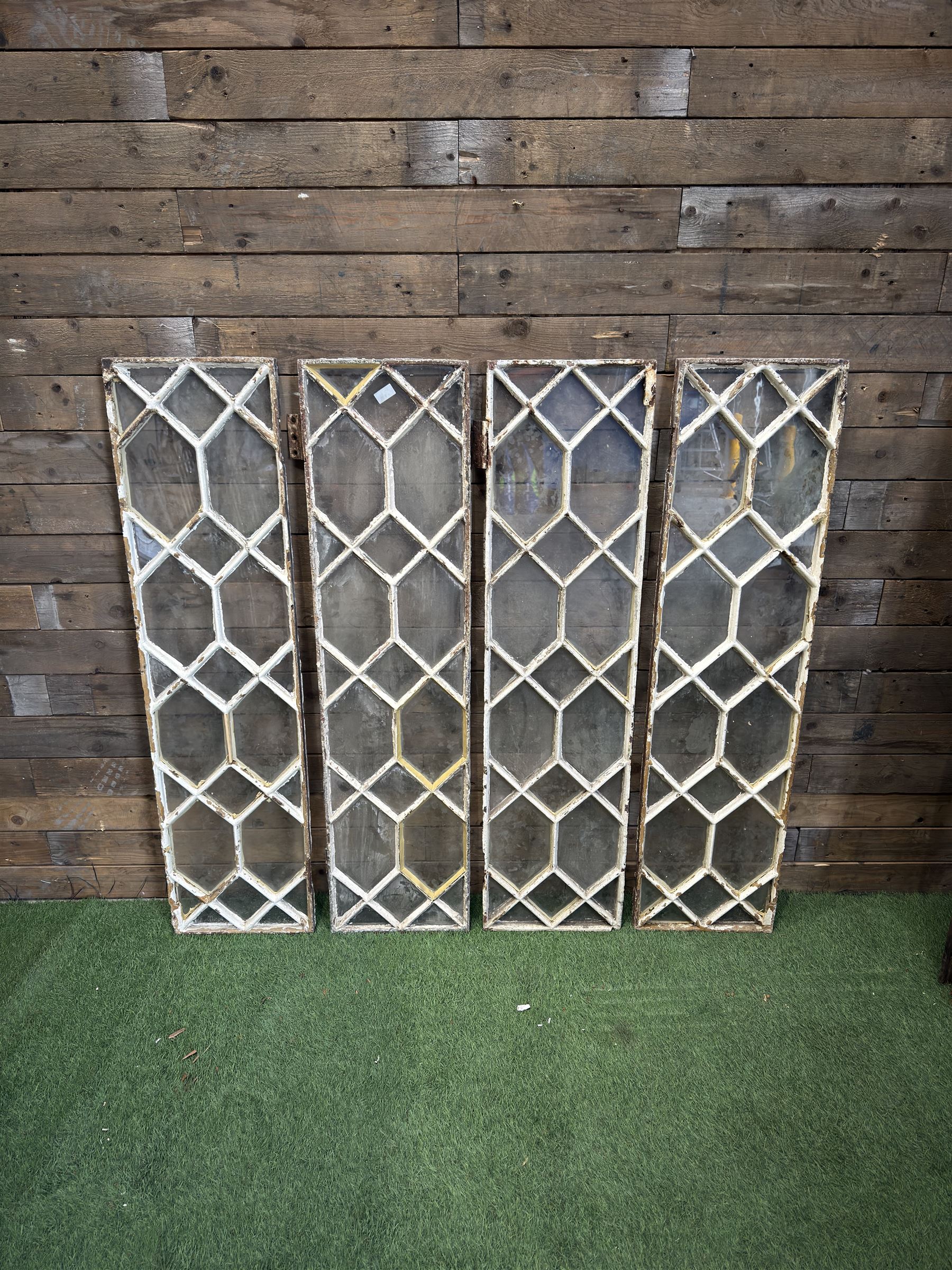Four 19th century cast iron windows, lattice glazed in white painted finish, 